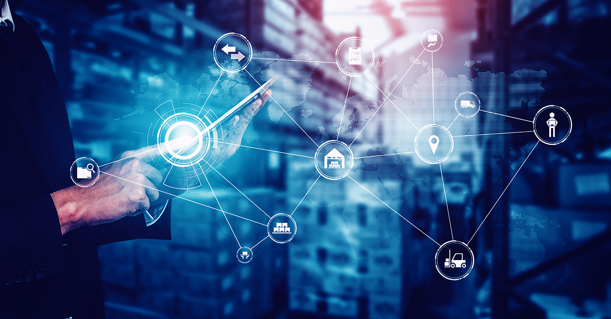 A warehouse worker uses a mobile device with shipping automation technology to configure business rules for processing parcel, LTL, and 3PL shipments.